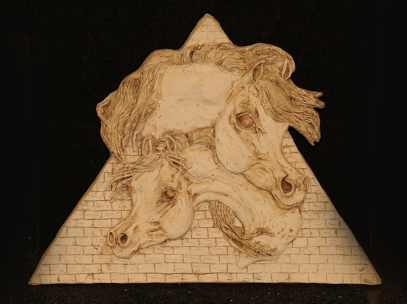 Two Arabian horse heads on a pyramid background. 