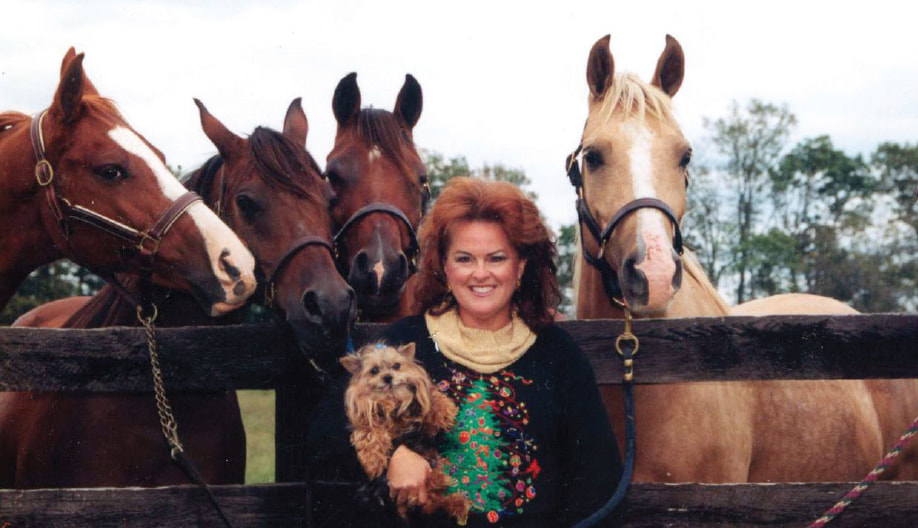 Photo of Summer Frost with four of her  horses and one of her Yorkies.